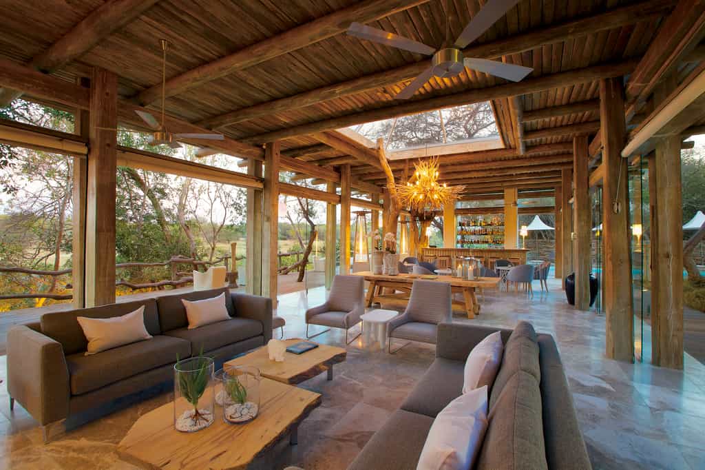 Modern whitewashed wood and vast sections of glass, complemented by a neutral colour palette, give Kapama Karula a contemporary African feel. The open-plan lounge and bar are spacious yet cosy, with skylights drawing in natural daylight and moonshine. Alternatively, enjoy the African sunshine on the outside wooden deck, with views over the meandering Klaserie River. Spotting leopard from the Kapama Karula dining room is not uncommon.