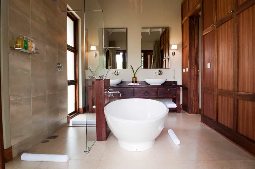 "The ensuite bathroom gleams with porcelain /glass and chromes finishing"