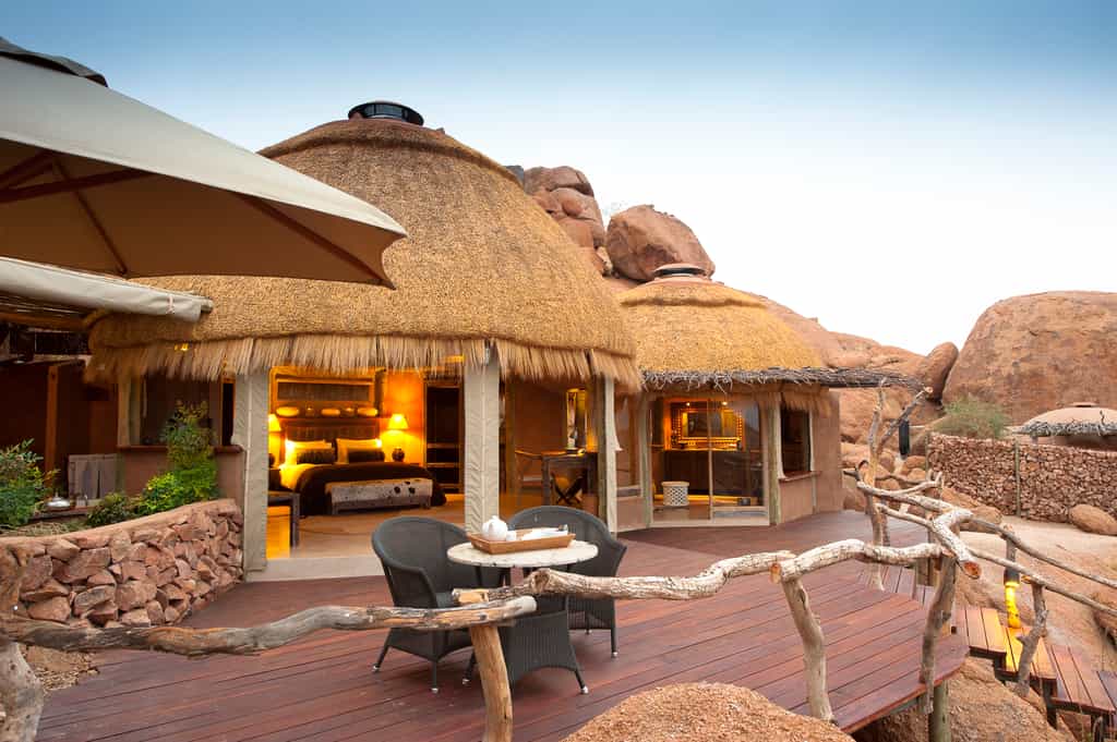 Nestled against the boulders with a small deck that extends the living space, connecting guests to the views beyond.