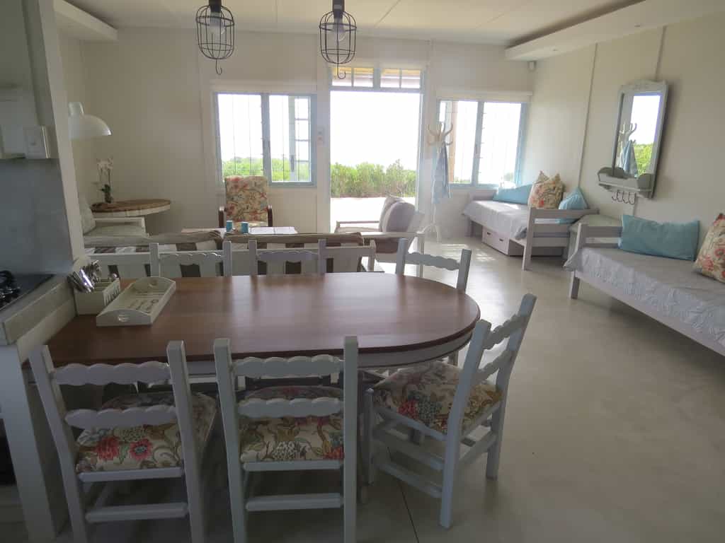 View from the kitchen area across the dining and living area (51sqm) towards the deck and beach.