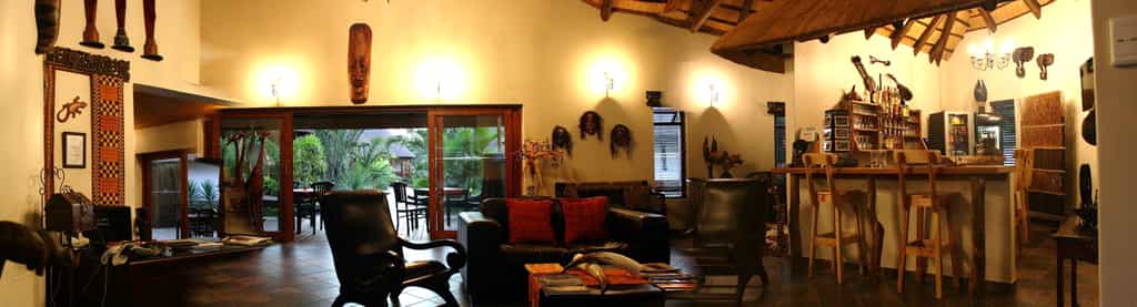 Fully stocked honesty bar close to comfortable chairs and couch