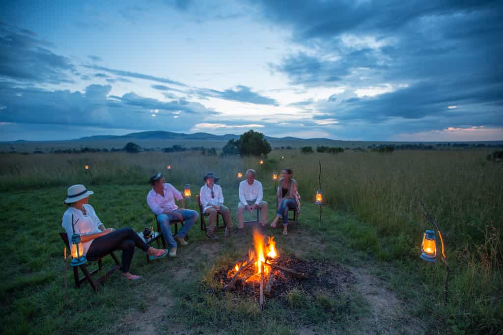 Enjoying a Masai Mara sunset by firelight