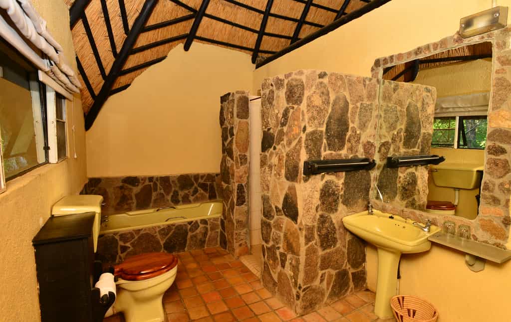 Old style bathrooms, with toilet, basin, shower and bath.