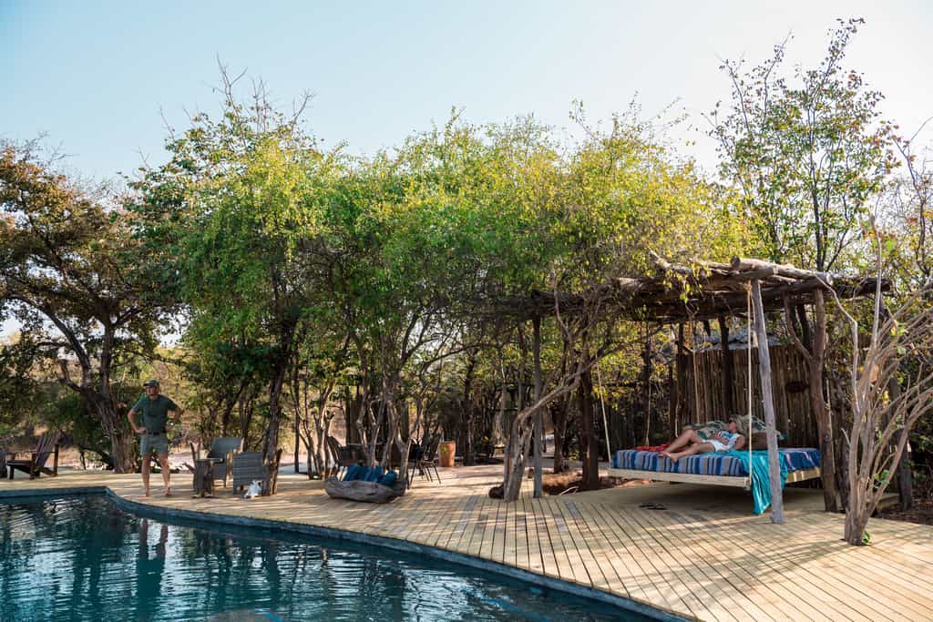 The lounge is completely open to the gentle breeze, shaded by a thatch roof with sprawling views of the main deck, beach and lakeshore.