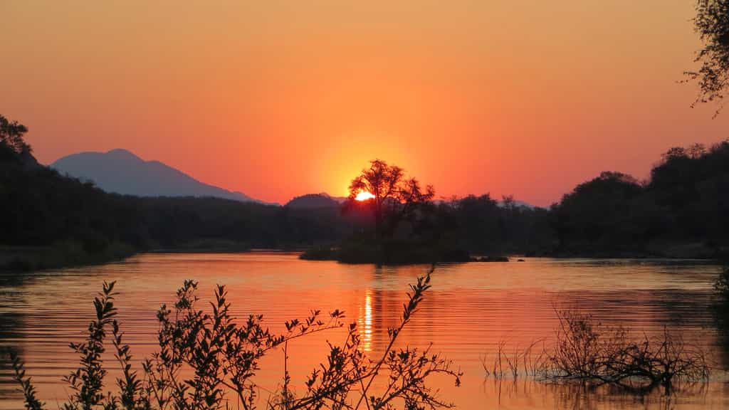 The most spectacular of African sunsets mirrored in the waters of the Kunene River