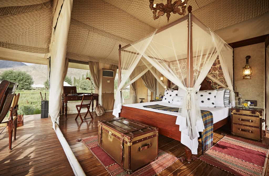 Nothing speaks more subtly about the elegance of brand TUTC than our Luxury Suite Tents. Beautifully-furnished and spacious, these tents rest royally on thick wooden decks, and treat you to a spellbinding 360° panorama of mystical mountains that encircle your location.  Whether you are on the king sized bed or in the stylish bathroom, views from the huge netted windows won't let you forget the magical landscape that envelops you. The triple layered tents, with their natural insulation ensure you stay warm and comfortable. Anti-weathering and fire-resisting fabric reinforces your security as our top priority.