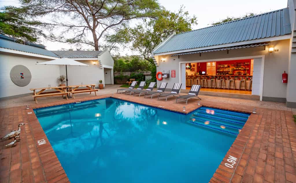 Enjoy a cold drink by the beautiful blue pool, it is the perfect way to cool down on a hot Victoria Falls day. 