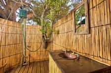 Oper air bathroom with bucket showers