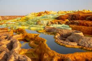 Explore the bubbling lava lakes and hot springs