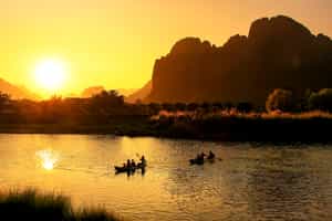 Cross the orange bridge over the Nam Song River