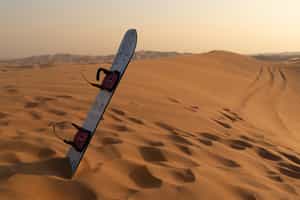 Go sandboarding down Erg Chebbi's desert dunes