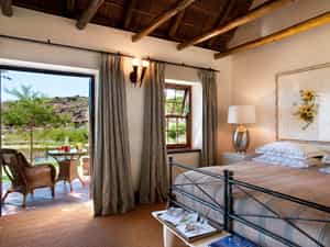 Double or twin sharing accommodation, with views of the landscaped indigenous gardens and one of the three nearby swimming pools.