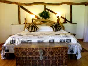 There are 3 individual well-spaced state of the art deluxe cottages, each with an en-suite bathroom and verandah with views of the sanctuary and the Rift Escarpment stretching for miles. The bedrooms have magnificent four-poster olive wood king-sized beds, roaring log fires, artisically decorated windows and handcrafted furniture
