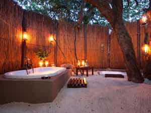 The romantic open-air bathrooms offer a unique experience. Enjoy the forest canopy with the stars peeking through as you relax in your bubble bath.