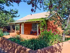 Each bungalow sits in a vegetable and herb garden surrounded by a low wall.