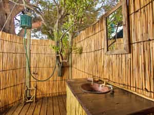 Oper air bathroom with bucket showers