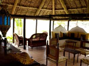 The open-sided makuti thatch beach bar provides the ideal outdoor seating area to enjoy the refreshing coastal breeze without the glare of the African sun