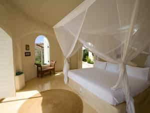Open to the ocean breeze, a luxurious pavilion bedroom.