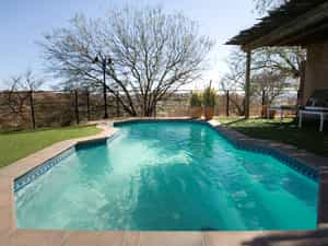 Beat the heat of a Namibian summer by cooling down in a sparkling blue  swimming pool!