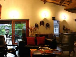 Fully stocked honesty bar close to comfortable chairs and couch