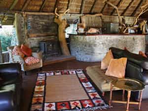Richly coloured local textiles, in shades of rust and burnt orange, are used throughout in support of the regions weaving community