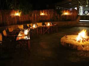 Guests are served fine fireside fare in the warm embrace of the evening fire.