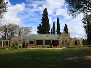 A 1930s colonial building set in a landscaped garden and surrounded by citrus plantations