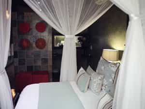 The Suite, Windfall Cottage, is privately situated under Marula trees and consists of a lounge with DSTV, romantic bedroom, en-suite bathroom and an outside shower in a privately fenced Boma area.
