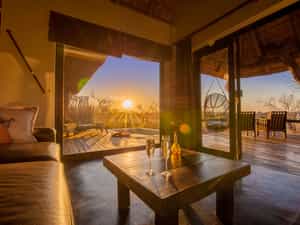 Sunset seen from within a luxury suite lounge at Billy's Lodge