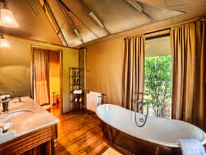 A decadent bath, or an adventurous outdoor shower await after a day of safari.