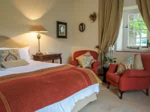 This lovely room is one of two standard twins. It can also be made into a standard double. This spacious room has a beautiful painted ceiling and en suite bathroom with separate bath & shower, plus his & hers basins.