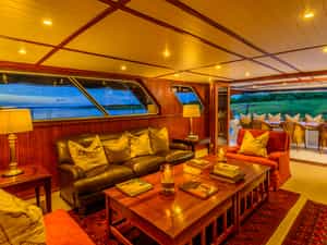 The middle deck offers a spacious and elegantly decorated dining area and lounge, opening up onto a covered verandah for al fresco meals.