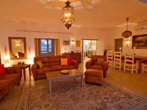 The huge indoor lounge with comfortable sofas and dining area with kitchen leading off. Perfect for chilly evenings.