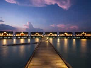 View of water villas during sunset