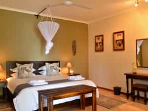 Double Chalet featuring king-size bed, en-suite bathroom, air-conditioning, refreshment station and private veranda with views of the Chobe River.