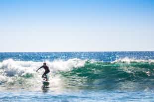 Take a surf lesson at Makaha beach in Lima