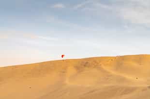 Paraglide above the sand ravines of Paracas