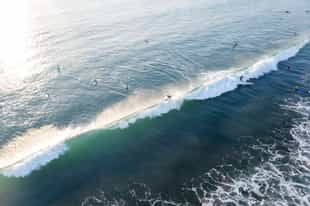 Take on the waves during a surf lesson in Uluwatu