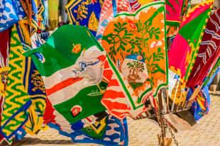 Observe artisans crafting silk flags in Siena