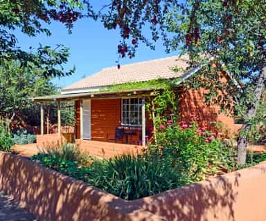 Each bungalow sits in a vegetable and herb garden surrounded by a low wall.