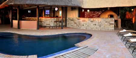 Overlooking the Zambezi, splash pool, bar and restaurant area with wood fired pizza oven.
