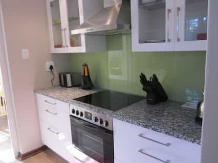 The kitchen in Quainton cottage includes an electric stove