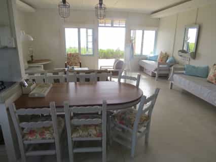 View from the kitchen area across the dining and living area (51sqm) towards the deck and beach.