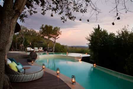Main area pool at sunset with view out onto the Madikwe 