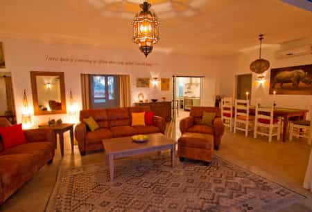The huge indoor lounge with comfortable sofas and dining area with kitchen leading off. Perfect for chilly evenings.
